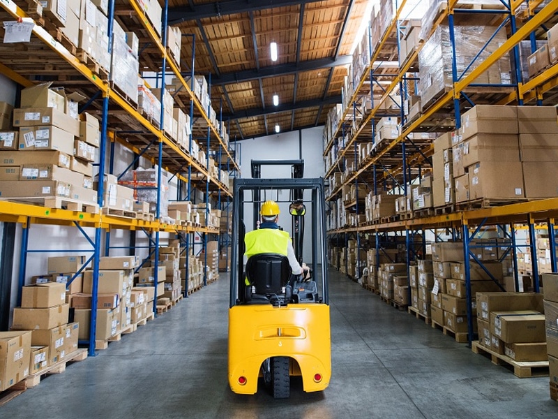 PCC Logistics Employee Navigating Warehouse